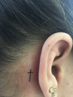 a person with a cross behind their ear