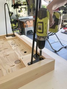 a driller is being used to attach holes in wood