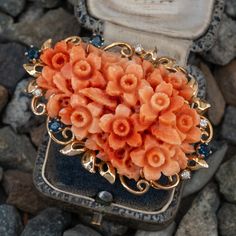 This beautiful vintage brooch features a carved floral bouquet design. The 14K yellow gold frame features an organic floral design and is accented with four (4), prong set, round mixed cut natural sapphires and four (4), prong set, round brilliant cut diamonds. The brooch measures 52.8mm X 36.0mm. Bouquet Brooch, Brooch Bouquets, Bouquet Design, Coral Jewelry, Vintage Brooch, Natural Sapphire, Floral Bouquets, Round Brilliant Cut Diamond, Round Brilliant Cut