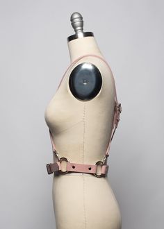 This harness belt is made in thick, strong, colorful PVC or leather. Criss-cross style shoulder straps are detachable and adjustable. Wear them criss-crossed in front, back, or both!. Buckles at front and shoulder straps. Fit is adjustable with buckles. Silver-toned nickel plated steel hardware on all colors.Shown in blush pink leather.Available in many leather and PVC colors. Neon Pink and Neon Orange PVC are UV/Blacklight reactive! All pieces are MADE TO ORDER, standard sizes XS-4XL. If your m Punk Harness With Adjustable Straps, Adjustable Strapped Harness With Belt, Adjustable Leather Harness With Belt, Leather Strapped Harness With Belt, Leather Harness With Straps, Leather Harness With Adjustable Strap, Adjustable Strapped Punk Harness, Leather Strapped Harness, Harness Belt