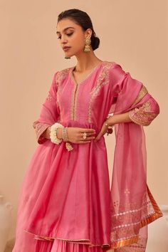 Flamingo pink peplum anarkali with tilla, patra, zari thread embroidery. Paired with gharara and geometric hand block print dupatta.
Components: 3
Pattern: Embroidery
Type Of Work: Tilla, patra, zari thread
Neckline: V neck
Sleeve Type: Three quarter
Fabric: Kurta: Silk Chanderi, Gharara: Georgette, Dupatta: Silk Organza
Color: Pink
Other Details: 
Tiered gharara
Gota lace embroidered hem
Sheer printed dupatta
Occasion: Sangeet - Aza Fashions Tissue Silk Anarkali Palazzo Set For Eid, Eid Anarkali Tissue Silk Palazzo Set, Eid Anarkali Set In Tissue Silk With Cutdana, Eid Tissue Silk Anarkali Set With Cutdana, Tissue Silk Anarkali Set For Eid, Eid Anarkali Set In Tissue Silk, Floor-length Slub Silk Sharara For Eid, Eid Floor-length Slub Silk Sharara, Navratri Anarkali Tissue Silk Palazzo Set