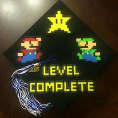 a graduation cap with the words level complete on it and video game characters attached to it