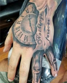 a man's hand with a clock tattoo on it