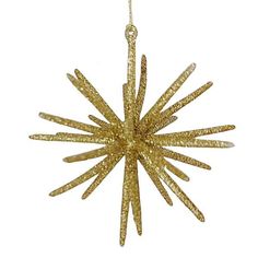 a gold star ornament hanging from a string