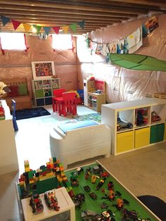 a child's playroom with toys on the floor