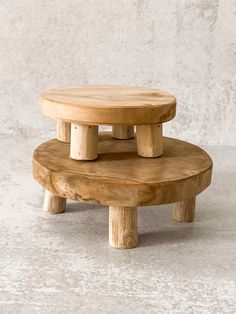 two wooden stools stacked on top of each other