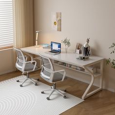 a white desk with two chairs and a laptop on it in front of a window