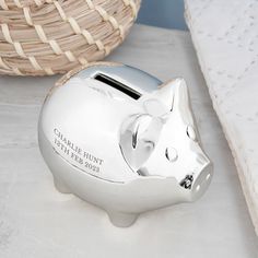 a pig shaped money bank sitting on top of a bed