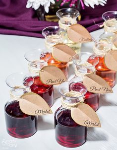 there are many different types of syrups in small bottles with labels on the lids