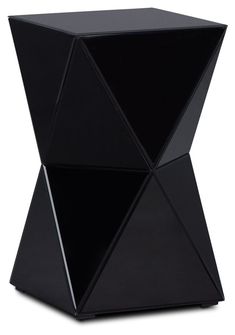 an unusual black side table with geometric shapes on it's sides and the top