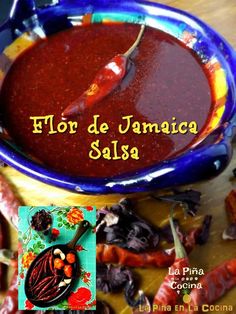 a bowl filled with red sauce next to other foods on a wooden table and the words hor de jamacco salsa written in spanish