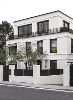 a large white building with black balconies