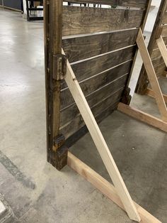 a wooden gate is being built in a building that has been constructed to look like an old barn