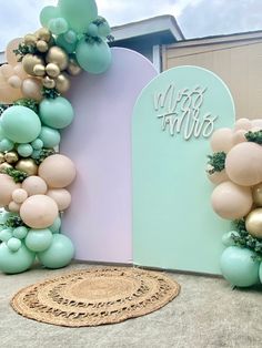 balloons and greenery decorate the entrance to an event