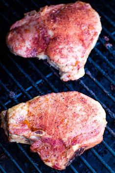 two pieces of meat cooking on a grill