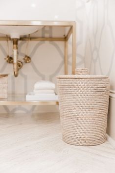 a bathroom with white towels and a basket on the floor