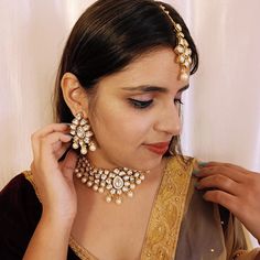 Exotic and snag-free kundan beaded necklace set with earrings. This is a stylish set with White Kundan. This set will work well with traditional, formal, and western formals. Eye-catching and unique jewelry that will set you apart. Gift this piece to a loved one, and see their face light up with joy. Best for gifting or for personal use, wear it to any occasion and become the spotlight. White color : R133C1445D418 SKU Formal Kundan Jewelry With Gota Work, Elegant Kundan Jewelry Set For Navratri, Kundan Sets For Formal Occasions In Temple Jewelry Style, Elegant Festive Jewelry Sets With Gota Work, Diwali Chandbali Bridal Necklace, Formal Gota Work Jewelry For Diwali, Kundan Jewelry Sets With Cutdana, Formal Kundan Necklace With Cutdana, Formal Kundan Jewelry Sets With Stone Work