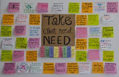 a bulletin board covered in post it notes with words written on the front and back