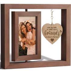 a wooden photo frame with a heart hanging from the front and an engraved keychain attached to it