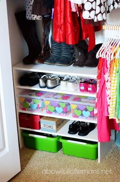 an image of a closet with clothes and shoes on the bottom shelf next to it