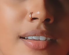 a woman with a nose piercing on her nose