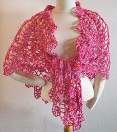 a white mannequin wearing a pink shawl