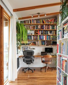 a home office with bookshelves full of books