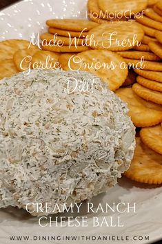 crackers and cheese ball on a plate with the words made with fresh garlic, onions and dill