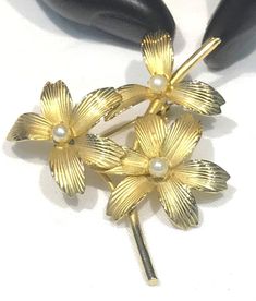 This very pretty vintage brooch satin gold tone textured flower petals with faux pearls (could very well be cultured)  The brooch measures 2" x 1.75" with a roll over clasp and is in very good vintage condition with the satin gold tone finish nice.  Unsigned and weighs 7 grams  Shipping prices vary on the weight of item. I do my best to keep shipping costs reasonable. The prices quoted are not trackable and is the least expensive airmail postage for most countries. If you want tracking, the cost Floral Brooch, Vintage Texture, Vintage Brooch, Flower Petals, Vintage Brooches, Faux Pearl, Favorite Jewelry, Brooch Pin, Brooches