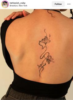 a woman's back tattoo with flowers on her left shoulder and the word love written in cursive writing