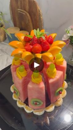 a cake with fruit and flowers on it