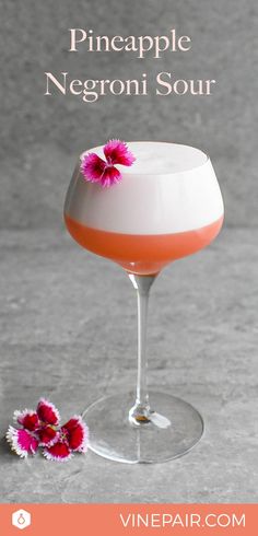 an orange and white drink in a wine glass with pink flowers on the rim text reads pineapple negroi sour