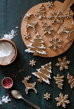 christmas cookies and sugar on a wooden board with spoons, salt and pepper shakers