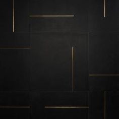 a black wall with gold lines on it