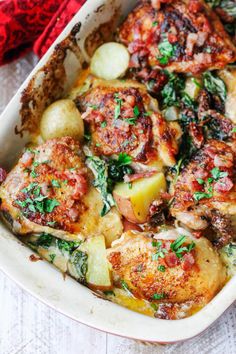 a casserole dish with meat, potatoes and spinach