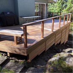 a wooden deck in front of a house