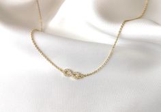 "Special offers: - orders over $100: free shipping upgrade to Parcel Post (no code required at checkout) - orders over $150: as above, PLUS 10% discount - enter code SPECIAL10 at checkout This beautiful necklace features a delicate infinity charm (12x5mm) inlaid with sparkling clear cubic zirconia, on a dainty flat cable chain, and all components are 18k gold plated and tarnish resistant.  Perfect to wear by itself or layer with other necklaces, this is a necklace you will enjoy for a long time, and that is sure to catch the eye! Various lengths available, all coming with a 4cm extension to ensure perfect fit (model wears 45cm long necklace). Please select your preferred length from the dropdown list. Please note that the image showing necklace lengths is a guide only, the actual position Gold Infinity Necklace, Infinity Necklace Gold, Love Symbol, Infinity Charm, Dainty Choker, Jewelry Elegant, Infinity Necklace, Necklace Crystal, Gold Choker