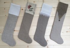 three pairs of socks sitting on top of a wooden floor