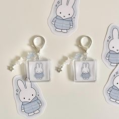 four keychains with cartoon characters on them