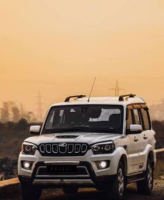 a white jeep driving down a dirt road