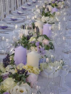 a long table with candles and flowers on it