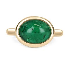 A bezel-set emerald cabochon ring in 14K yellow gold. Featured here is this lovely 4.77-carat natural, earth-mined, emerald cabochon. This stone displays a gorgeous, vivid dark green color, and very good luster. This natural beauty is set in a 14K yellow gold bezel setting. Setting Style: Bezel / Solitaire set Setting Material: 14K Yellow Gold Gold Weight: 5.3 Grams Main Stone: Emerald Cabochon Shape: Oval Cut Weight: 4.77-Carats Clarity: Translucent Color: Dark Green Luster: Very Good Origin: Z Emerald Cabochon, Emerald Gem, Dark Green Color, Solitaire Setting, Colombian Emeralds, Cabochon Ring, Unisex Jewelry, Pinky Ring, Natural Earth