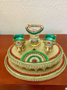 a wooden table topped with lots of different types of jewelry on top of each other