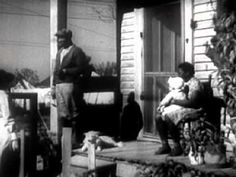 an old black and white photo of people sitting on the porch