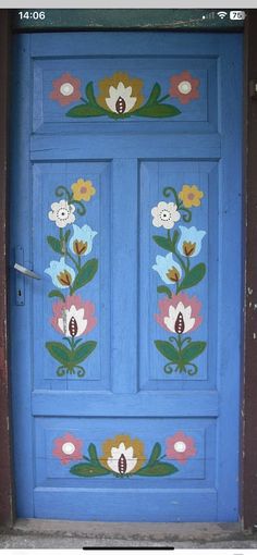 a blue door with flowers painted on it