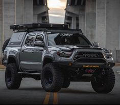 a gray toyota truck parked on the side of a road