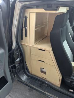 the interior of a vehicle with its door open and drawers opened to show what's inside