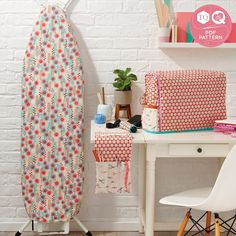 an ironing board sitting next to a white desk