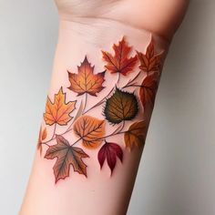 a woman's arm with leaves painted on the side of her body and it is shown