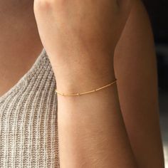 Minimal and modern, our satellite bracelet is perfect for layering. Single, double layered or matched with your other bracelets will make a statement for any occasion. P R O D U C T * D E T A I L S  - Wire wrapping detail - Available in Sterling Silver, 14k Gold Filled or 14k Rose Gold Filled L E N G T H - Model is wearing Gold bracelet - This bracelet is measured opened from end to end  - Not sure what length to get? Step 1: Use a string to mark the spot you would like your bracelet Step 2: Mea Minimalist Chain Bracelet With Tiny Beads, Minimalist Beaded Bracelets With Satellite Chain, Everyday Chain Bracelet With Round Beads, Delicate Bracelets For Layering, Minimalist Beaded Bracelets With Satellite Chain For Everyday, Adjustable Minimalist Satellite Chain Bracelet, Delicate Layering Bracelets, Modern Bracelets With Satellite Chain, Delicate Adjustable Beaded Bracelets With Satellite Chain